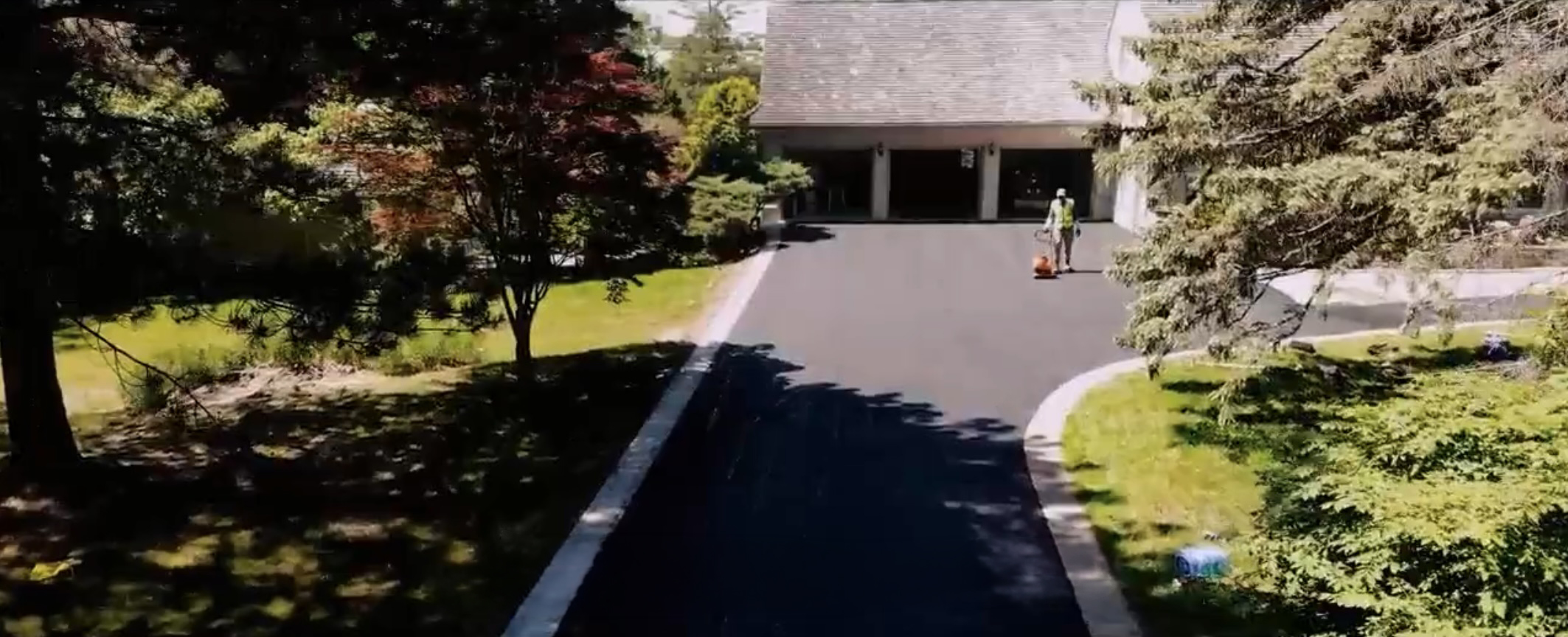 Freshly paved asphalt driveway leading to a GTA home